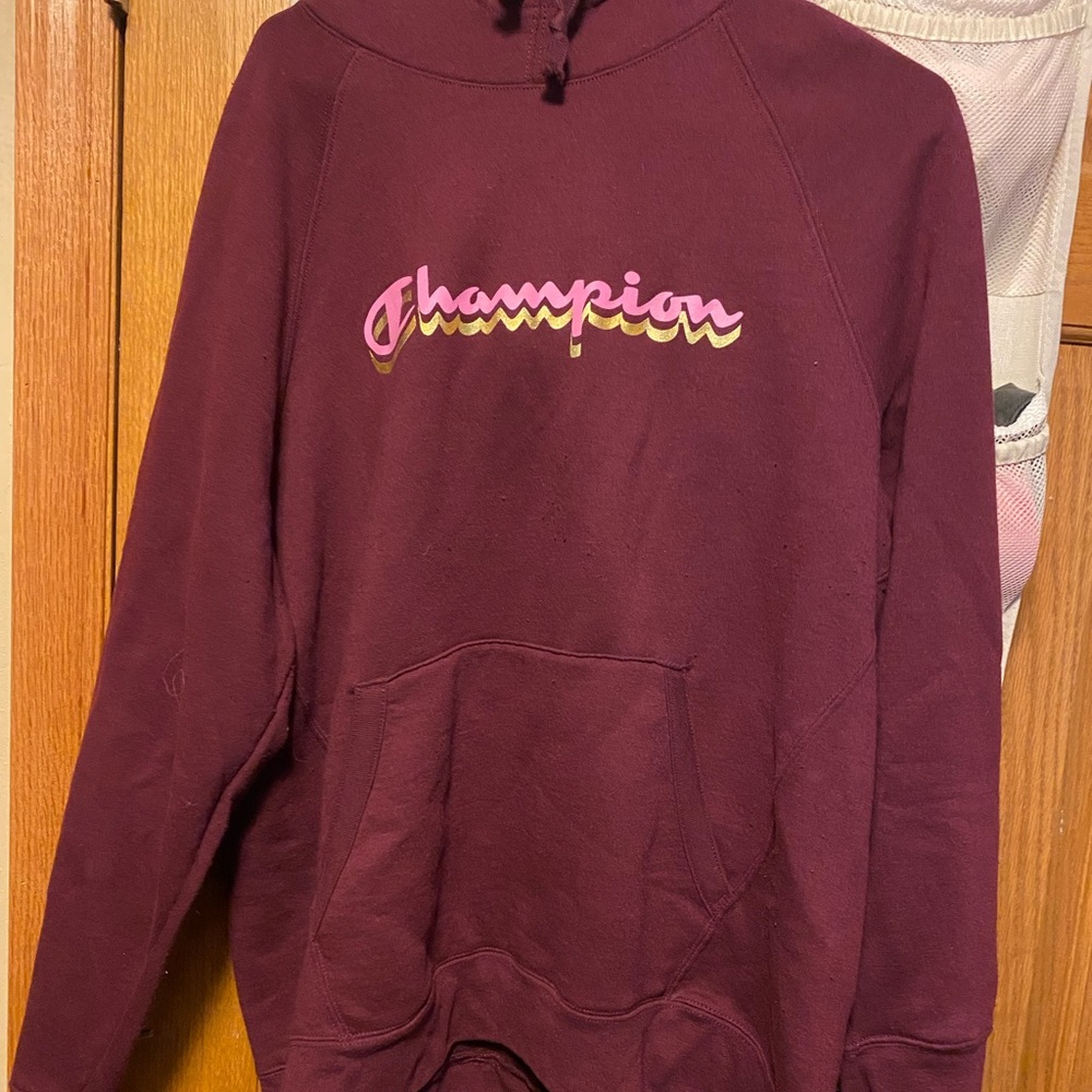 Champion sweatshirt color is maroon. Size 2xL. Never worn.